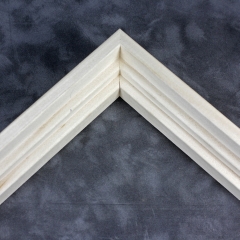 Simple tiered 15/16 " floater. This thin, stepped floater is unstained and left the natural wood color. The top edge has an angled inner corner, sloping towards the contents of the frame. The surface has a wood grain texture.
