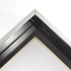 Classic L-shaped 1-5/8 " floater frame. This frame is bright silver with a mirrored finish. The inside base of the frame is high gloss mars black. A very slight horizontal grain pattern is visible in only certain light and viewing angles.